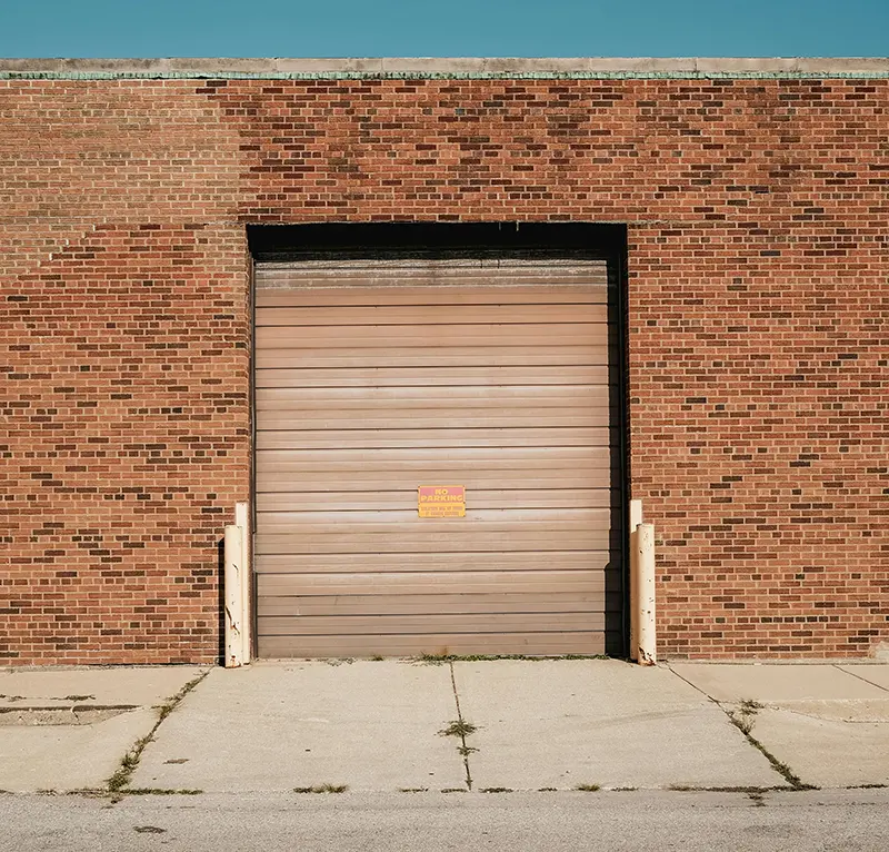 Steel rolling door on the exterior of a brick building