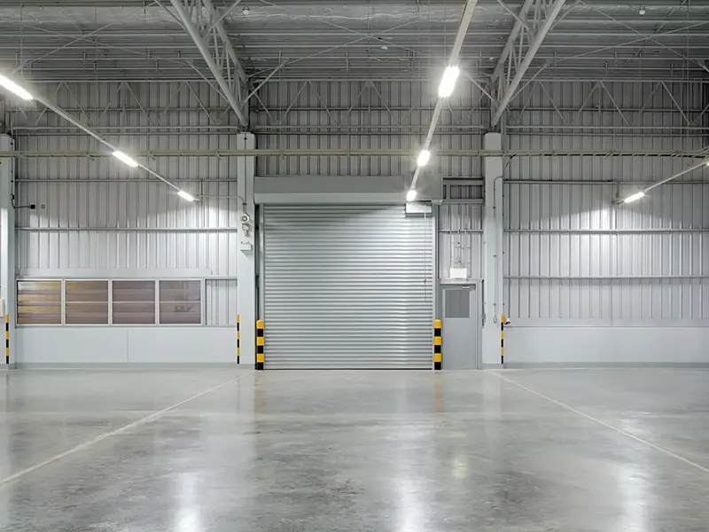 Wide view of a metal overhead door inside a industrial facility